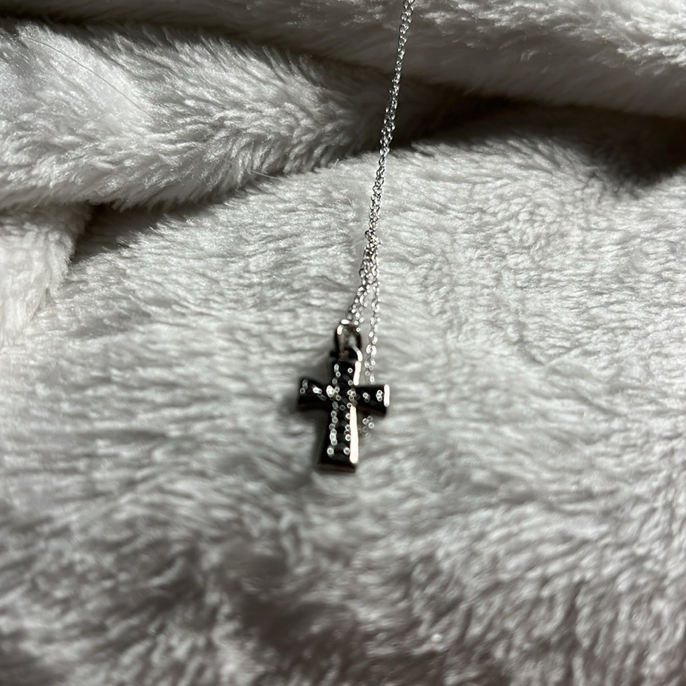 Necklace sterling silver only 12 inch so could be good for a young girl. Cross